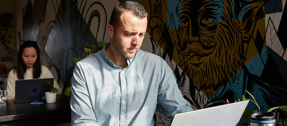 Scott Rowe working on a laptop